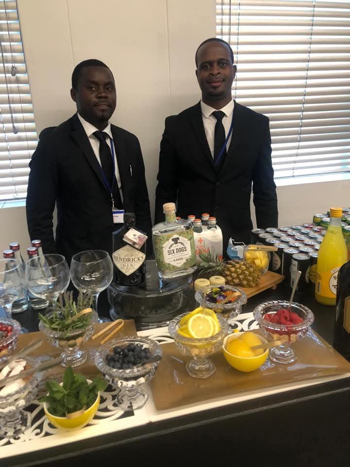 Professional bartender crafting a cocktail behind the bar